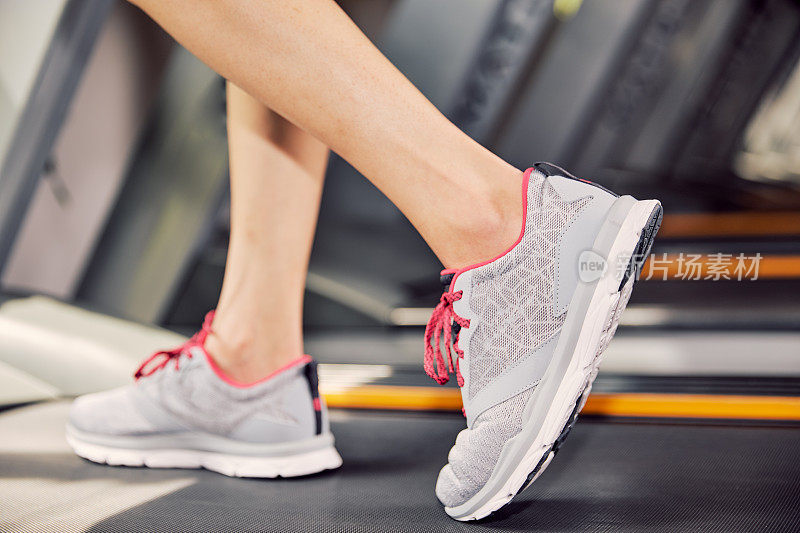 Fitness girl running on treadmill